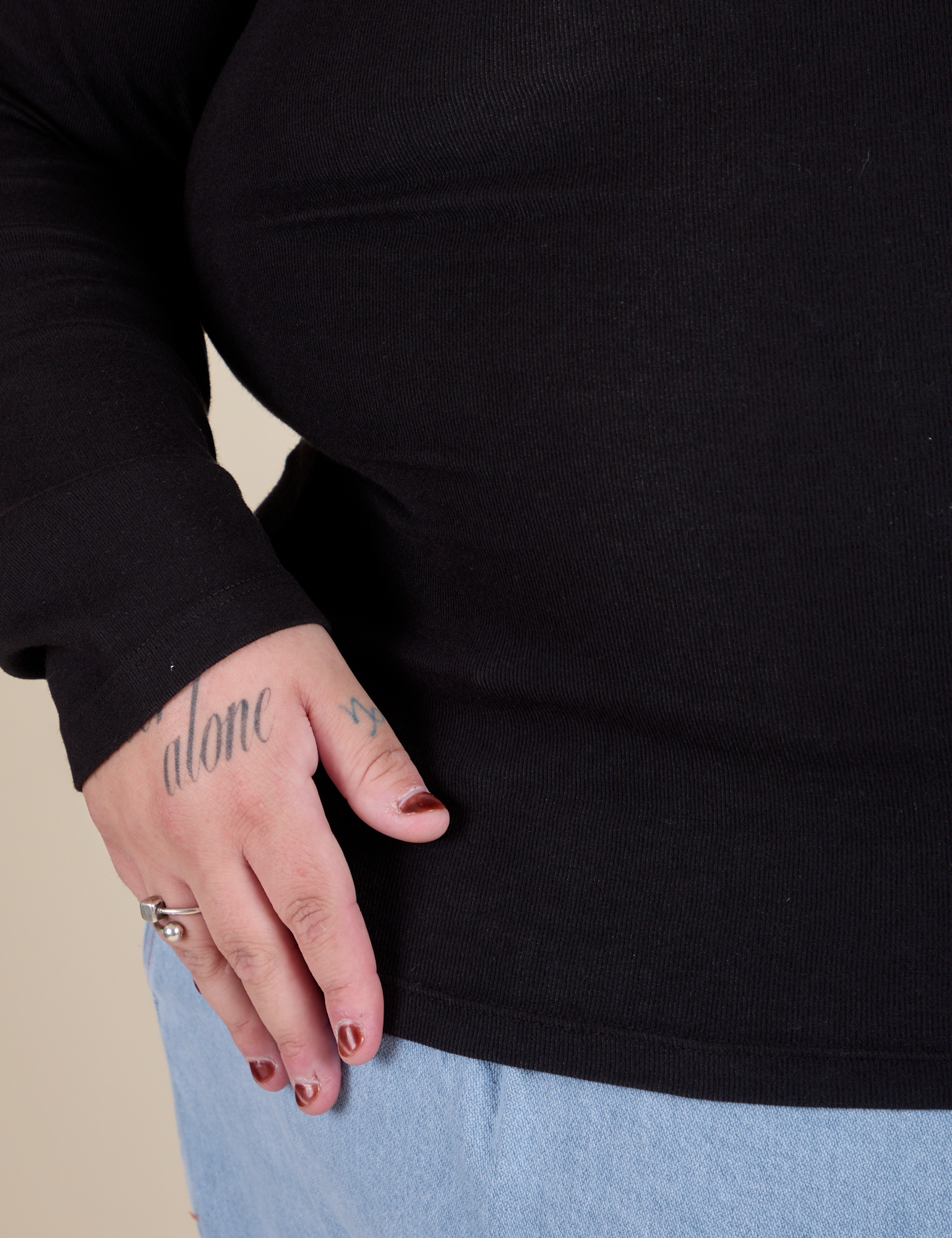 Long Sleeve Baby Tee in Basic Black bottom close up on Sam