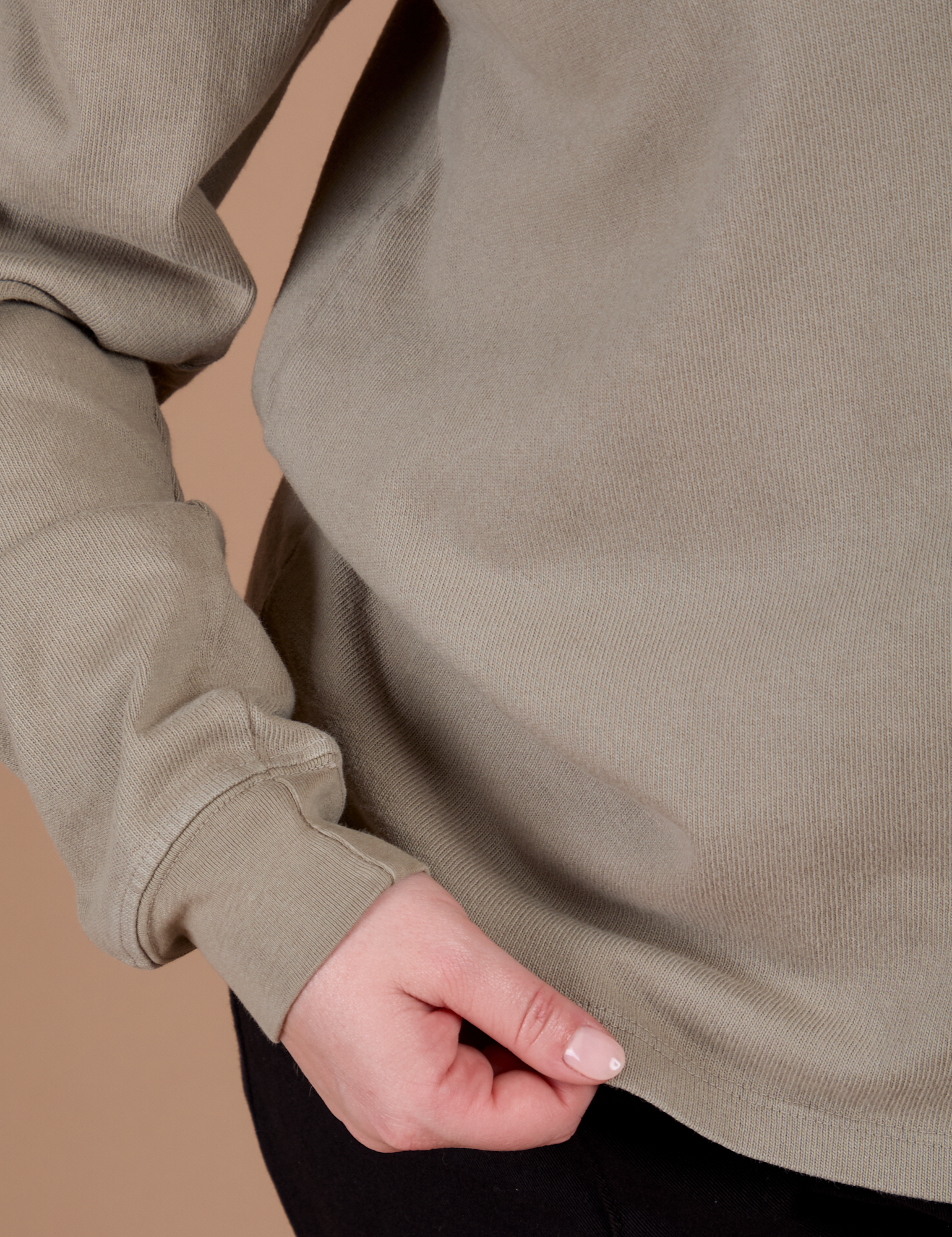 Long Sleeve Burly Tee in Khaki Grey bottom close up with Lish holding the hem