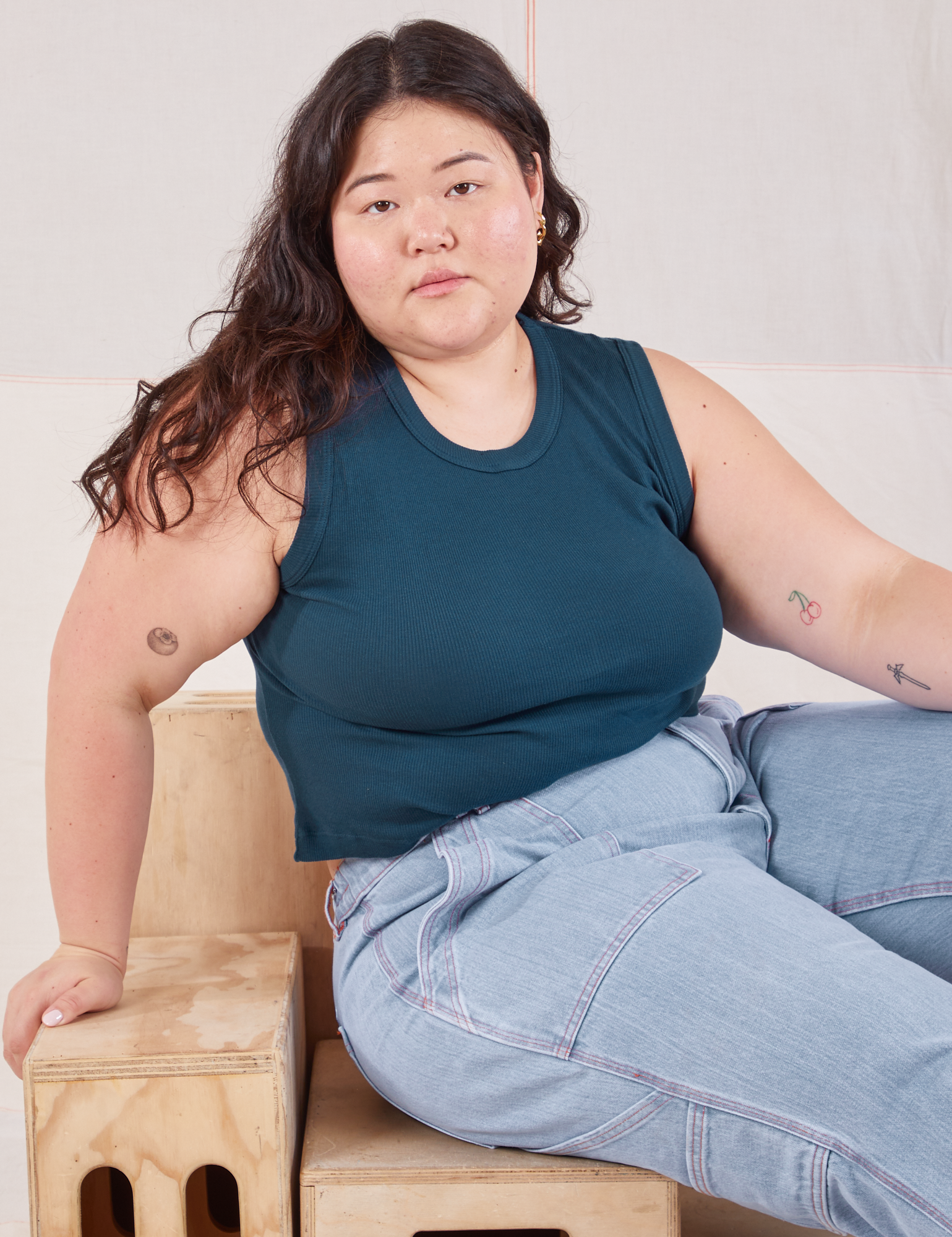 Ashley is wearing Muscle Tee in Lagoon and light wash Carpenter Jeans