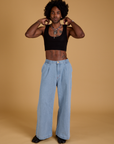 Jerrod is wearing Mini Tank in Basic Black and light wash Indigo Wide Leg Trousers