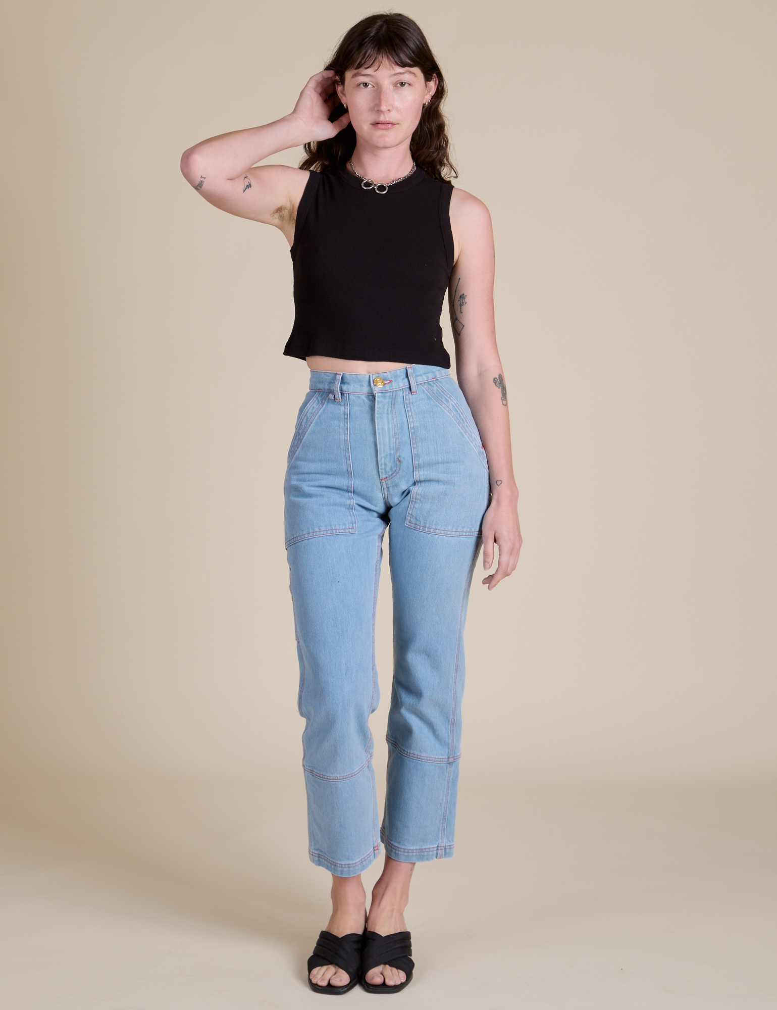 Alex is wearing Muscle Tee in Basic Black paired with light wash Carpenter Jeans