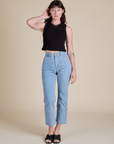 Alex is wearing Muscle Tee in Basic Black paired with light wash Carpenter Jeans