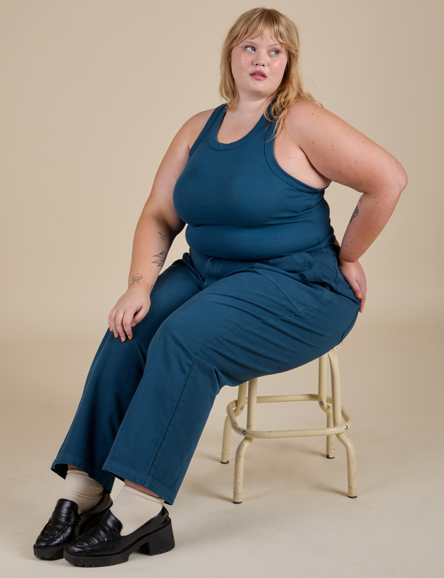 Juliet is wearing Racerback Tank in Lagoon and lagoon Work Pants