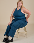 Juliet is wearing Racerback Tank in Lagoon and lagoon Work Pants