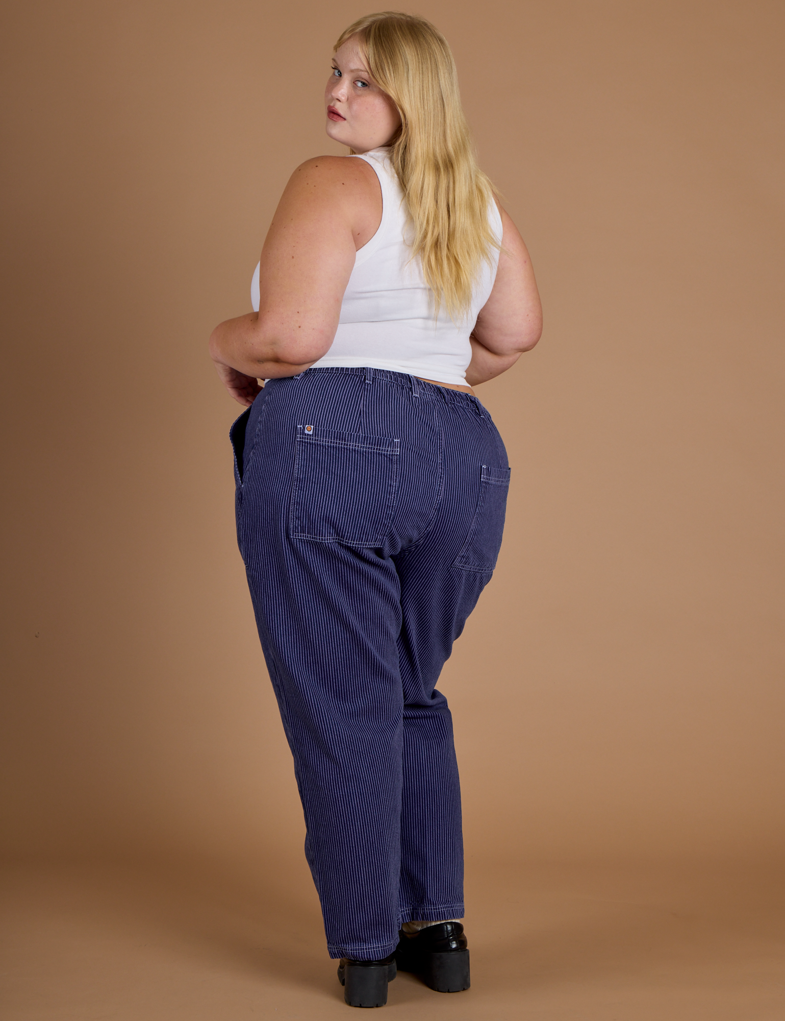 Railroad Denim Work Pants in Faded Grape Overdye angled back view on Juliet