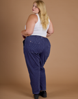 Railroad Denim Work Pants in Faded Grape Overdye angled back view on Juliet