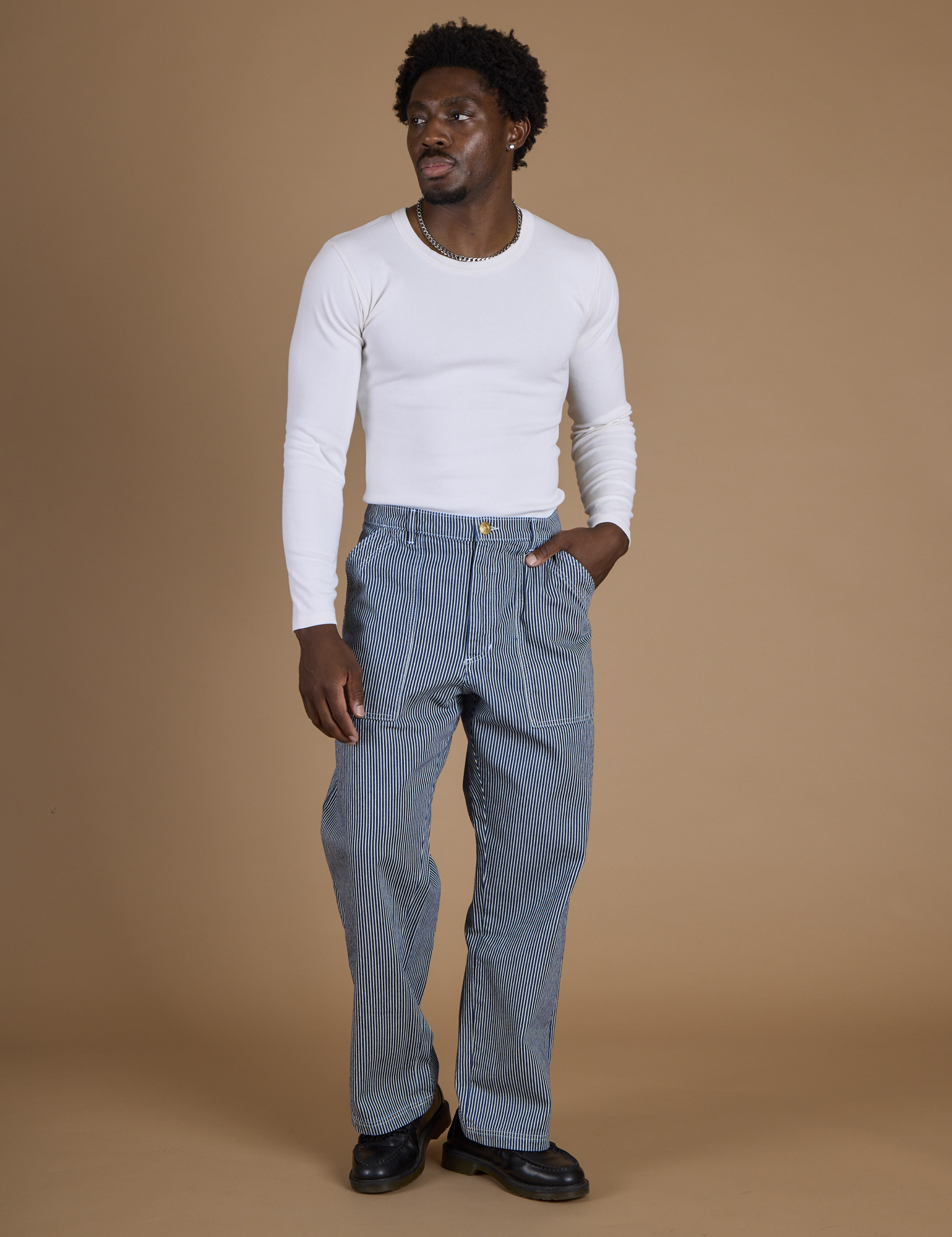 Isaac is 5’10” and wearing M Railroad Denim Work Pants in Natural paired with long sleeve baby tee in Vintage Tee White