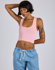 Kira is 5’10” and wearing P Cropped Tank Top in Baby Pink