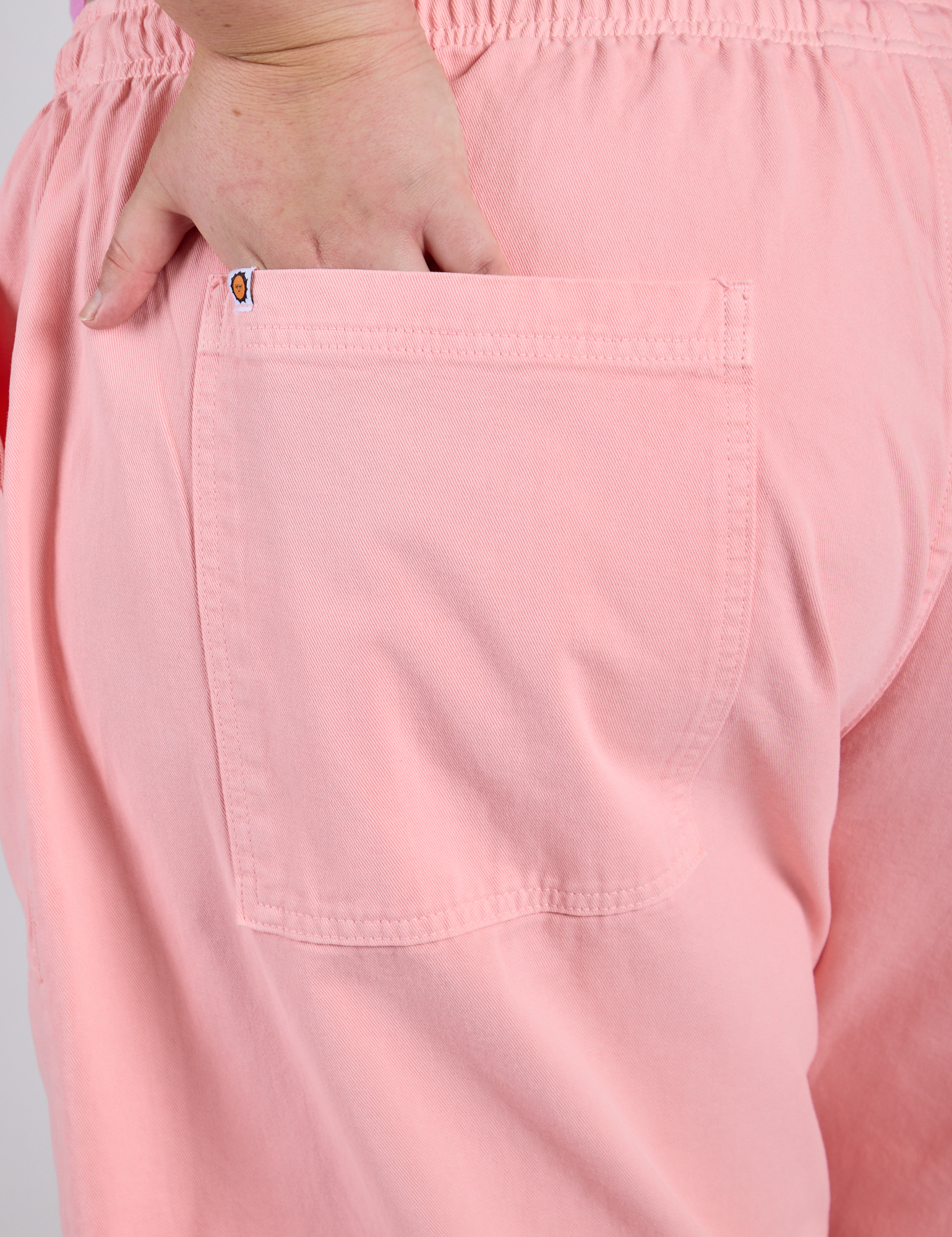 Close up of Juliet's hand in the back pocket of Drop Pocket Cargo Pants in Baby Pink