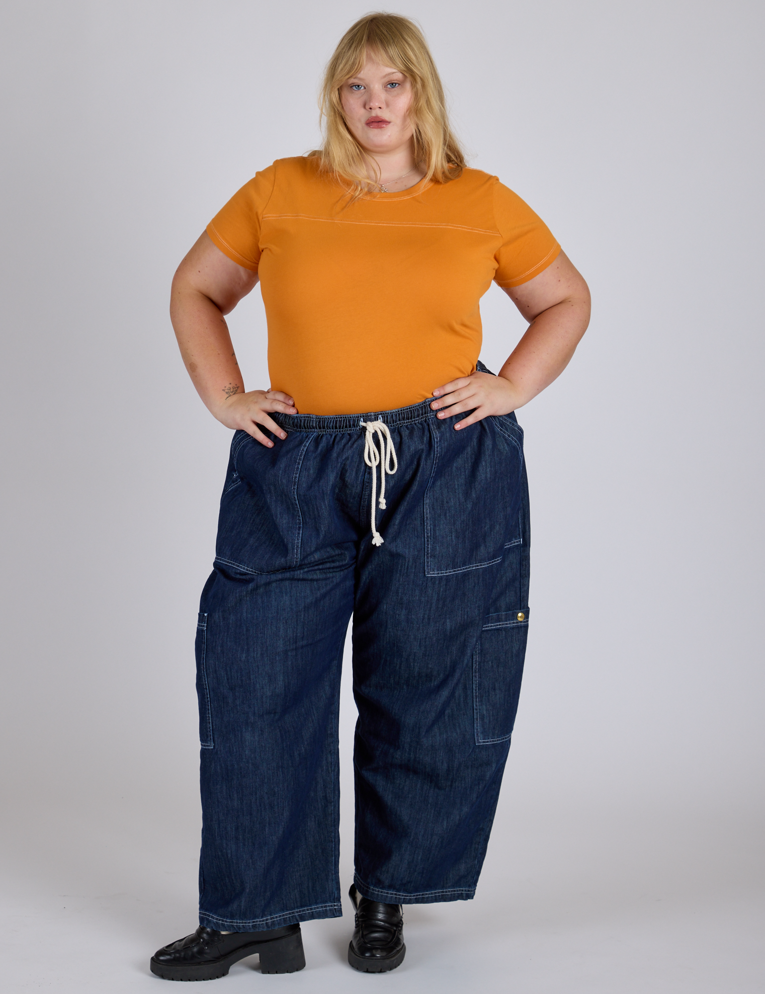 Juliet is wearing Jr. Varsity Tee in Creamsicle Orange and dark wash Denim Drop Pocket Pants