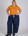 Juliet is wearing Jr. Varsity Tee in Creamsicle Orange and dark wash Denim Drop Pocket Pants