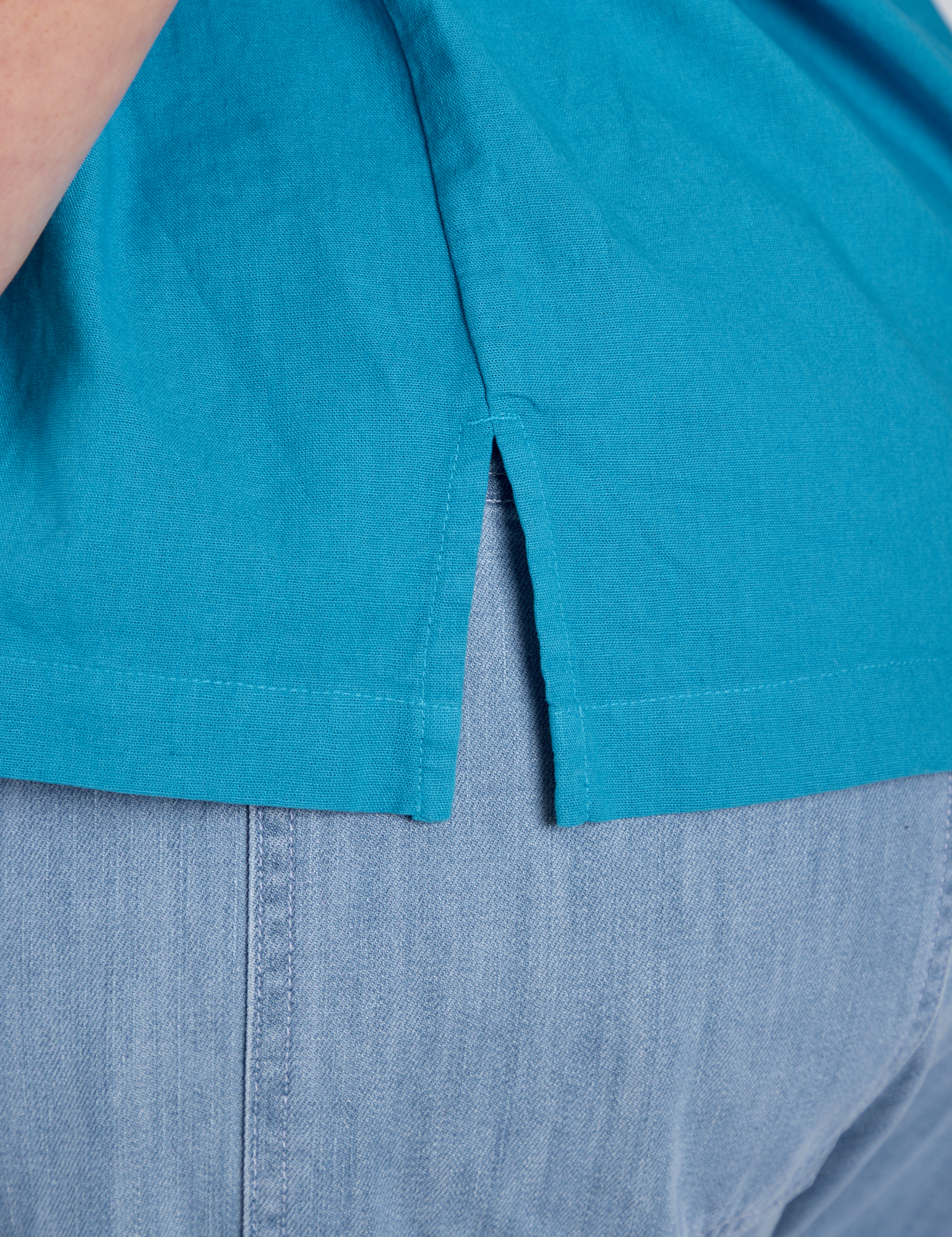 Close up of Pantry Button-Up in Hawaiian Blue side vent on Juliet