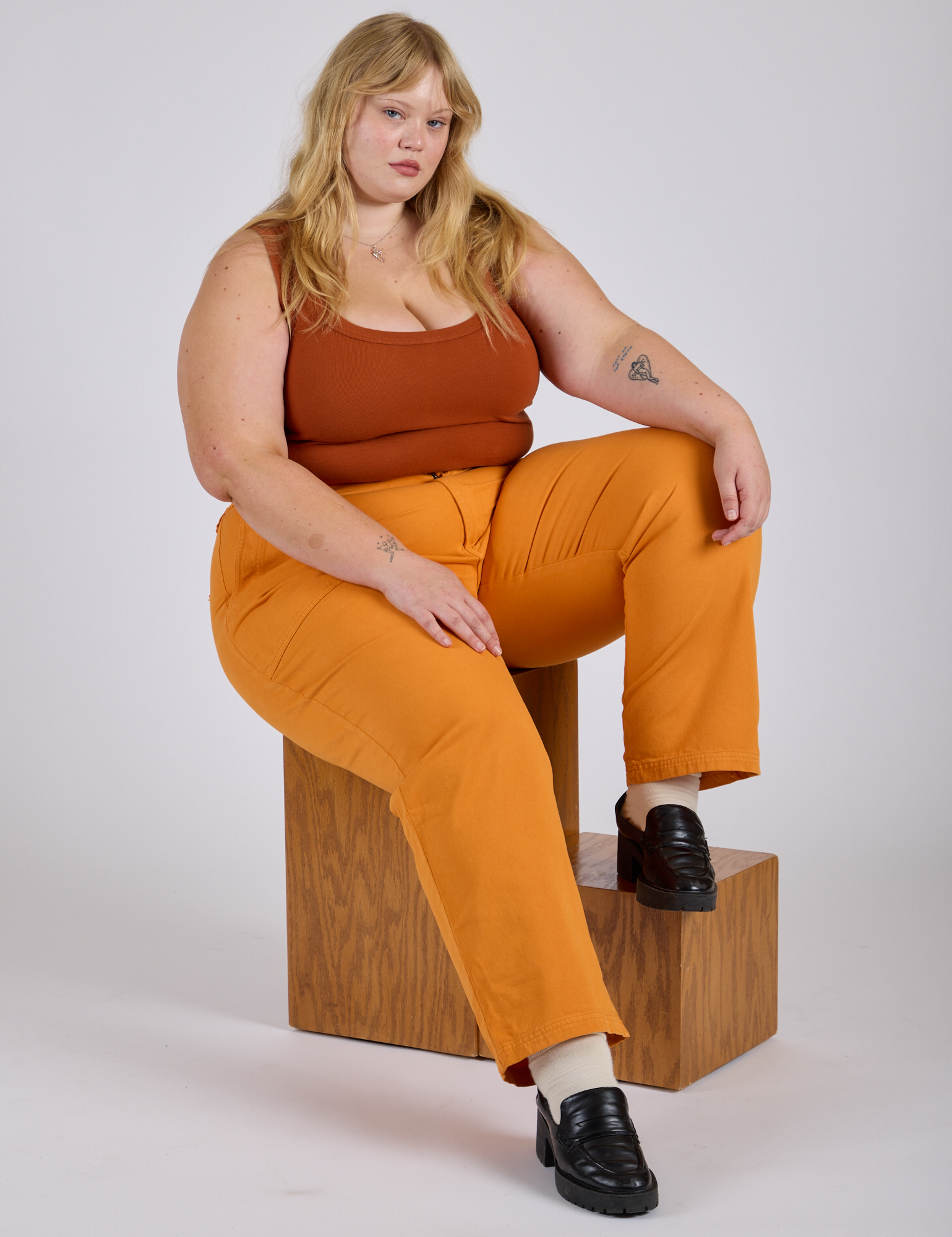 Juliet is wearing  Work Pants in Creamsicle Orange and burnt terracotta Cropped Tank