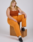 Juliet is wearing  Work Pants in Creamsicle Orange and burnt terracotta Cropped Tank