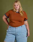 Juliet is wearing Vintage Ringer Tee in Burnt Terracotta and light wash Carpenter Shorts