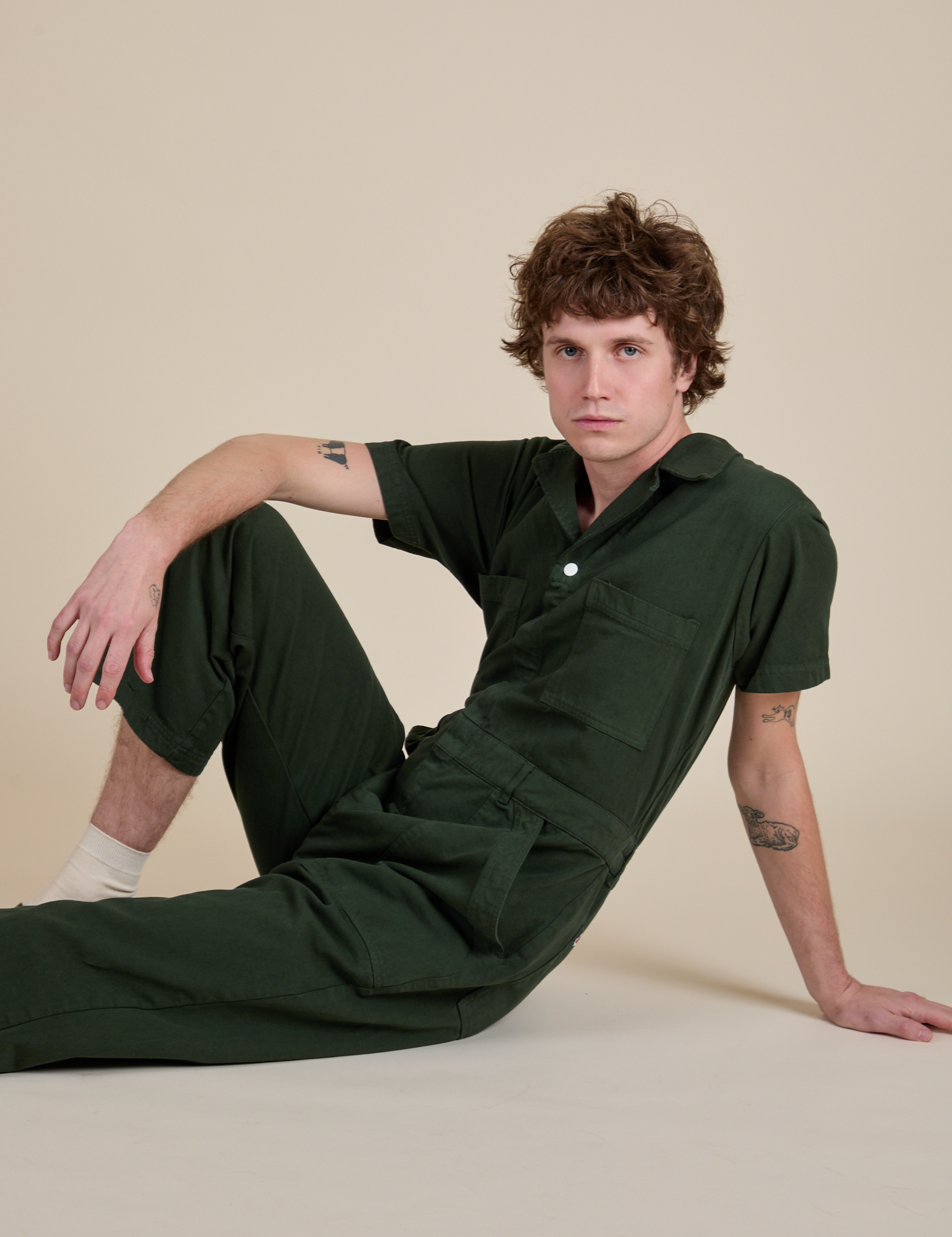Quinn is wearing Short Sleeve Jumpsuit in Swamp Green
