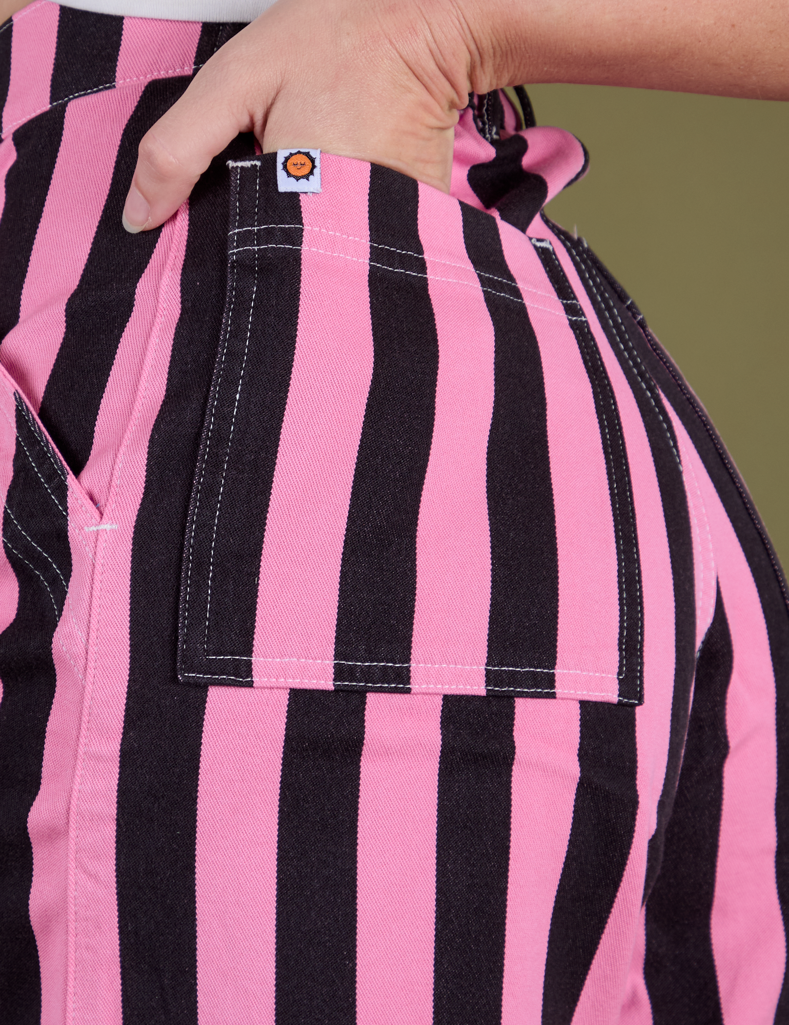 Close up of Alex's hand in the back pocket of Longline Work Shorts in Bubblegum Pink