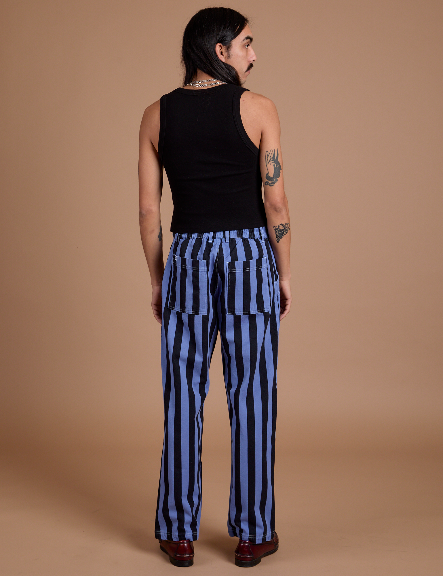 Back view of Black Stripe Work Pants in Cornflower Blue and black Cropped Tank on Anthony