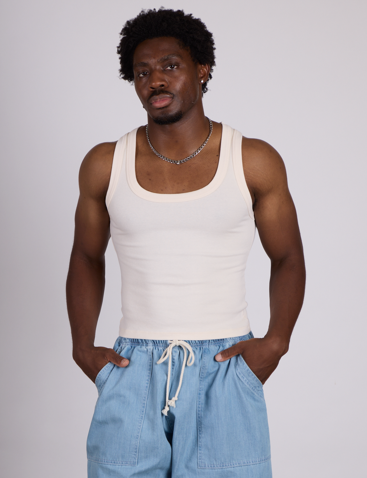 Isaac is 5’10” and wearing M The Tank Top in Vintage Tee Off-White