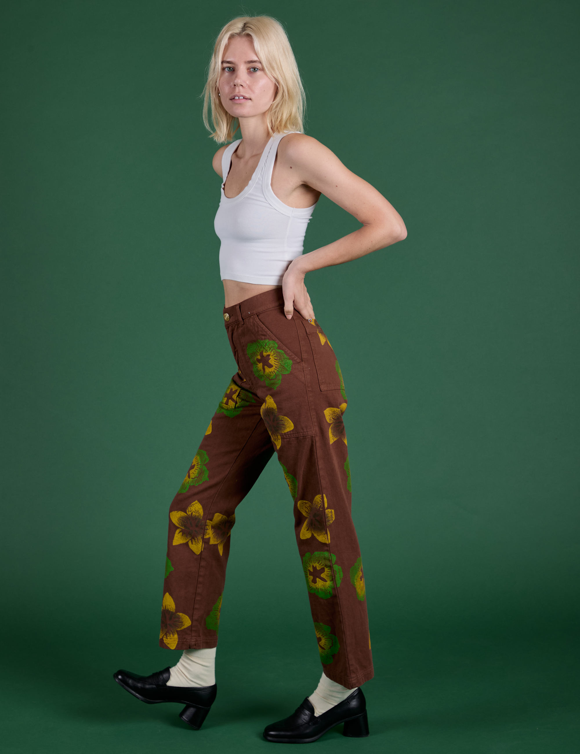 Side view of Floral Painted Work Pants in Brown and Cropped Tank in Vintage Tee White on Madeline