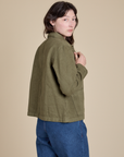 Angled back view of Denim Work Jacket in Surplus Green on Alex