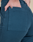 Close up of Alex's hand in the back pocket of Work Pants in Lagoon