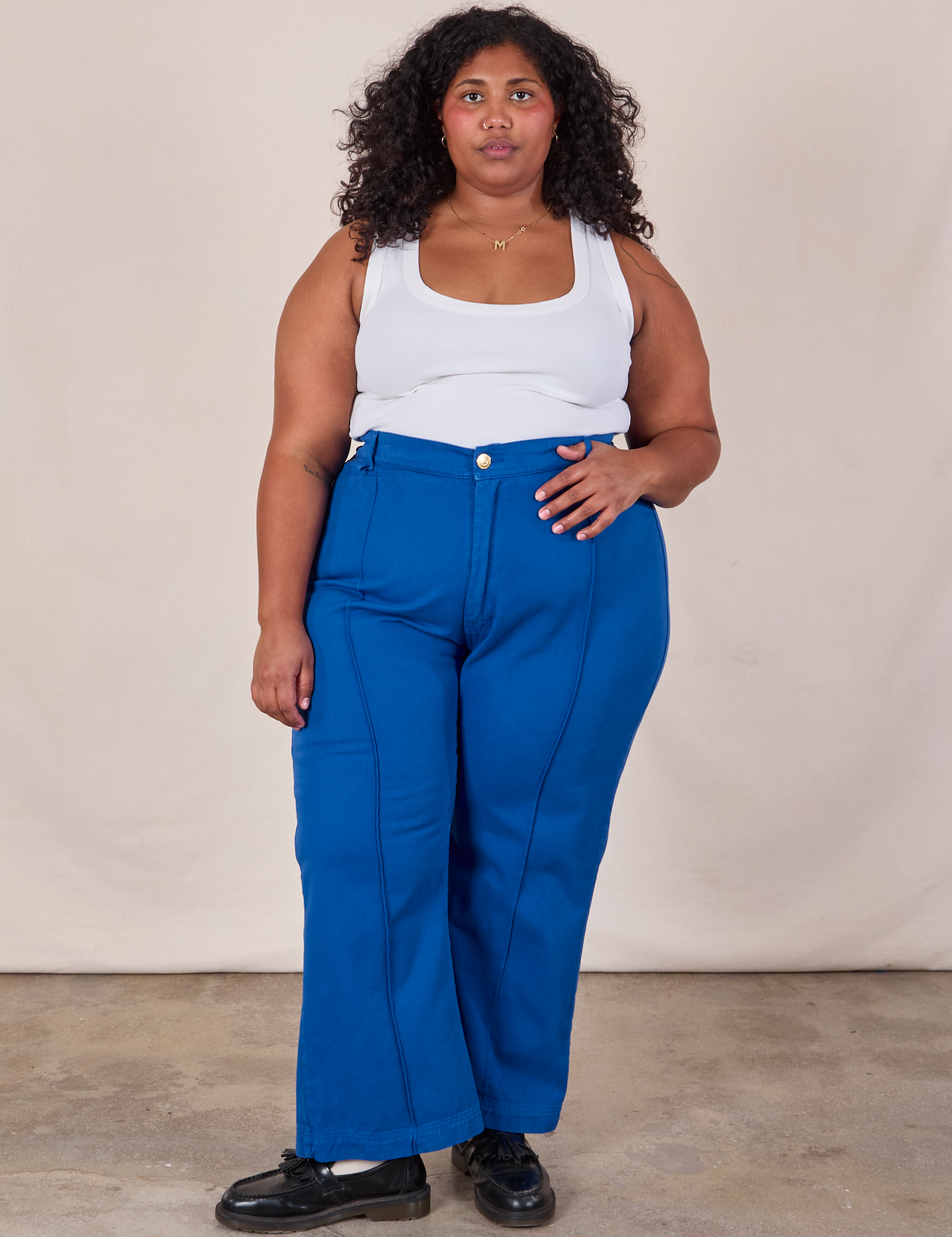 Morgan is 5'5" and wearing 2XL Western Pants in Royal Blue paired with a Cropped Tank in Vintage Tee Off-White