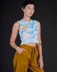 Angled side view of Alex wearing the Morning Moon Airbrush Muscle Tee