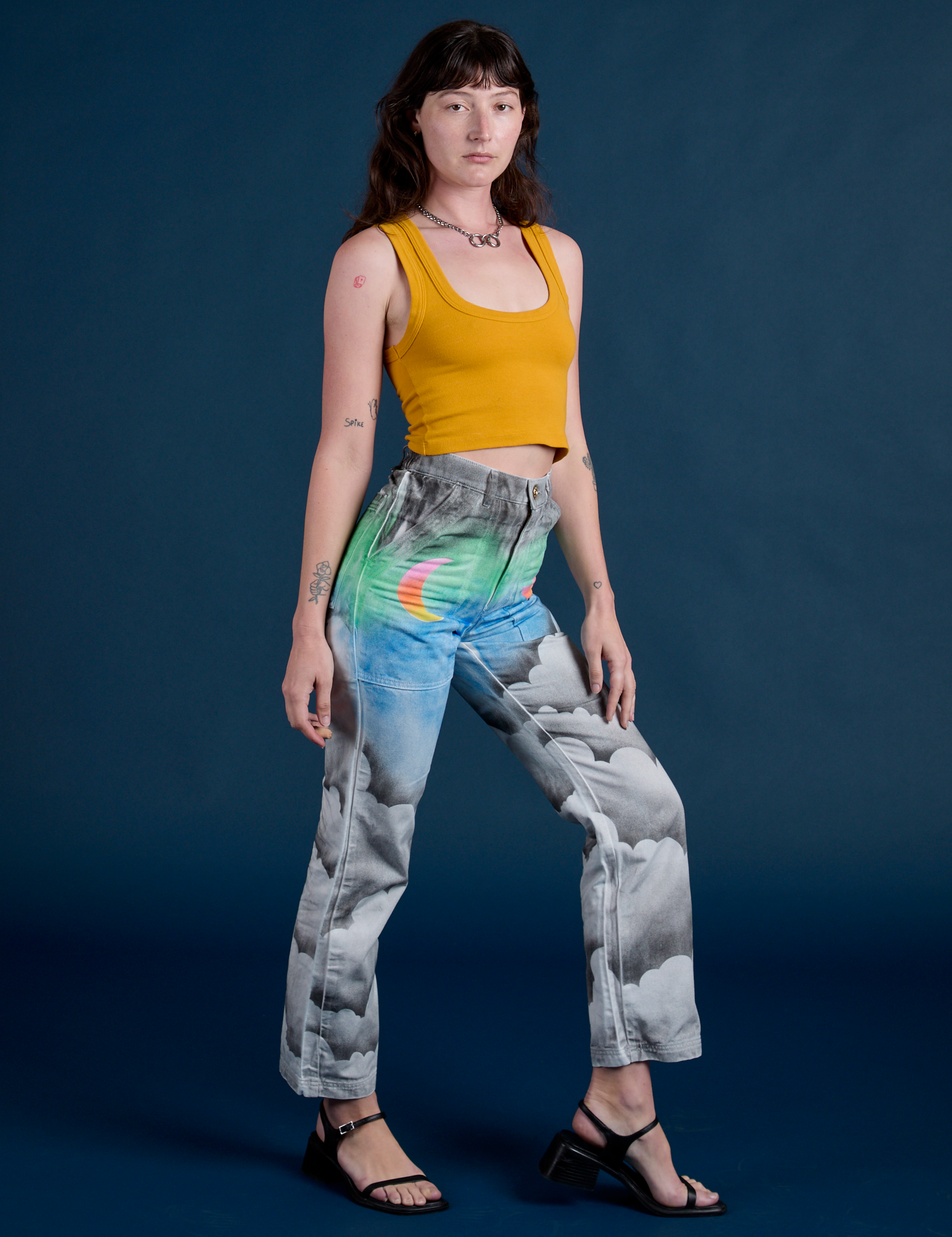 Angled front view of Work Pants in Night Sky Airbrush and mustard yellow Tank Top on Alex