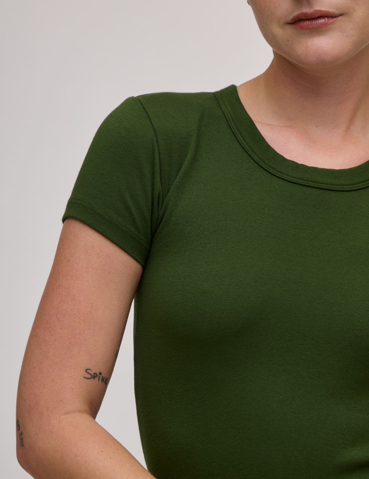 Front close up of Baby Tee in Evergreen on Alex