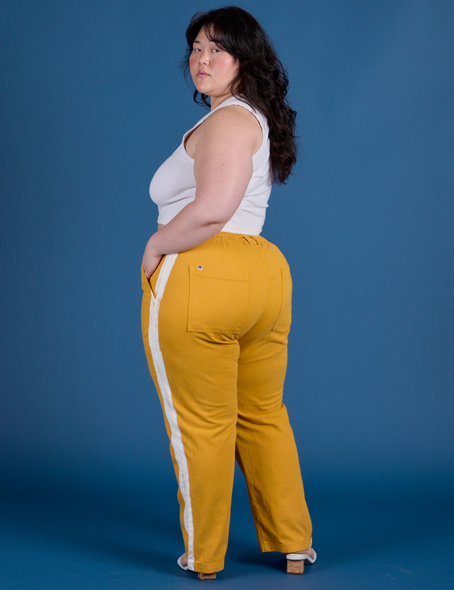 Painted Work Pants in Mustard Yellow angled back view on Ashley