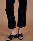 Carpenter Jeans in Black pant leg close up on Alex