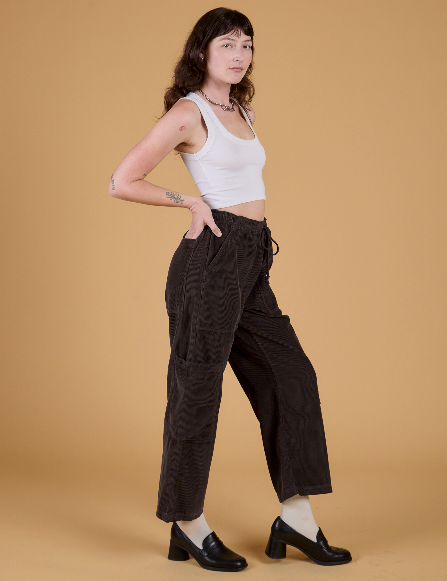 Side view of Corduroy Drop Pocket Cargo Pants in Espresso Brown and Cropped Tank in Vintage Tee White on Alex