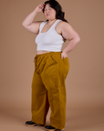 Side view of Drop Pocket Cargo Pants in Spicy Mustard and Cropped Tank in Vintage Tee White on Ashley