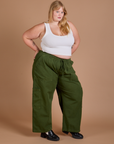 Angled view of Drop Pocket Cargo Pants in Evergreen and Cropped Tank in vintage tee white