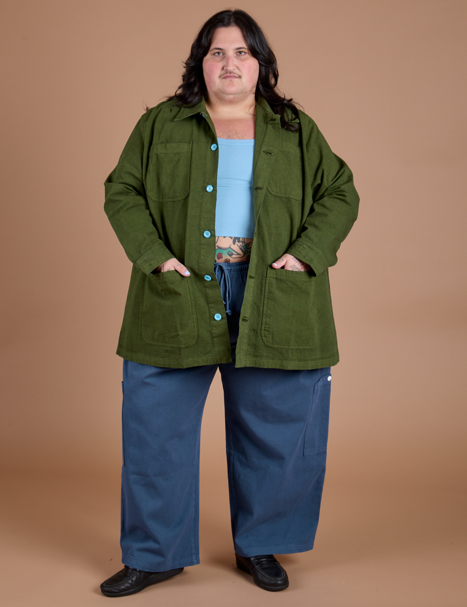 Sam is wearing Ripstop Field Coat in Evergreen and french blue Drop Pocket Cargo Pants