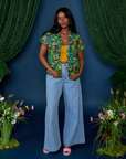 Kandia is wearing Pond Party Pantry Button-Up paired with light wash Indigo Wide Leg Trousers