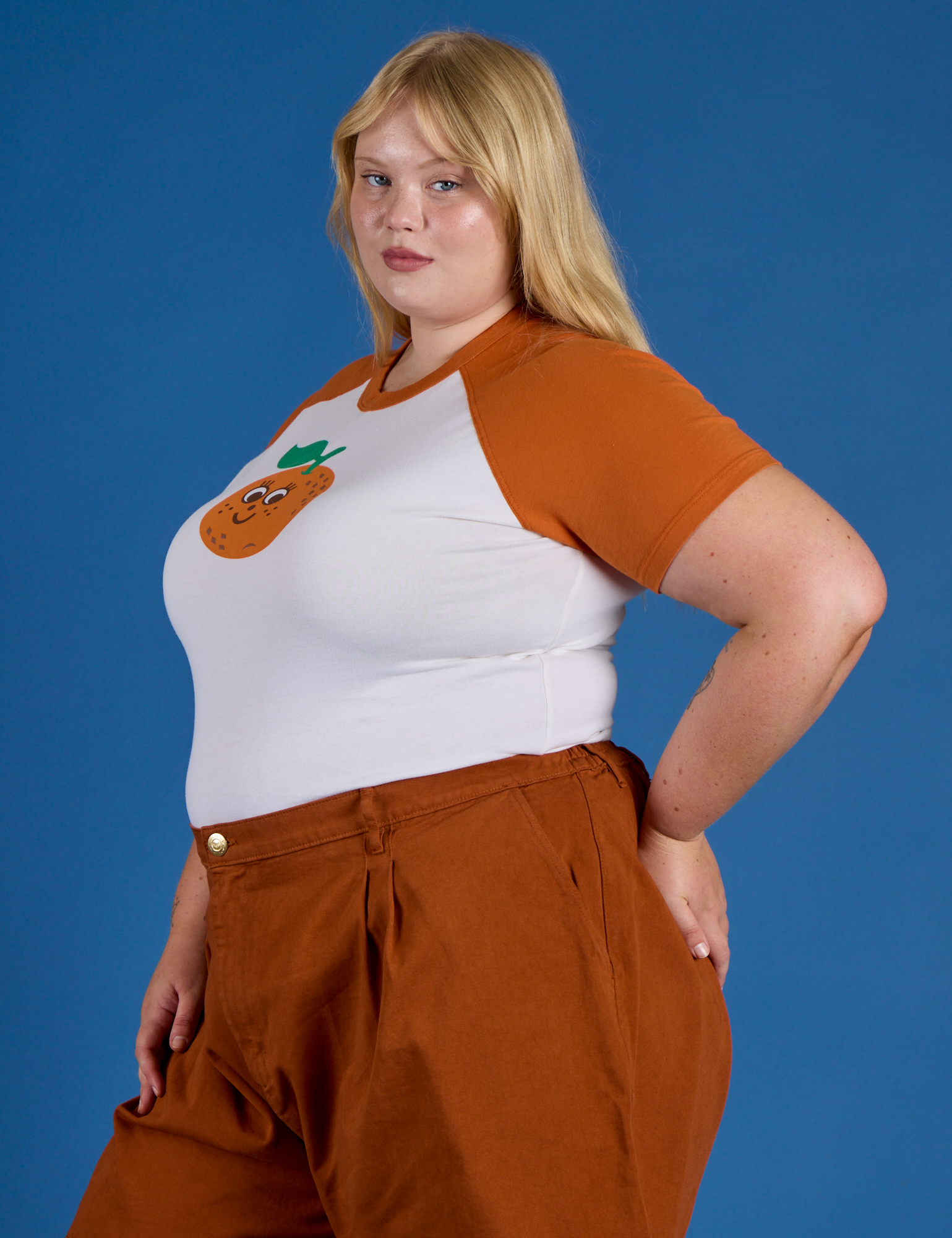 Side view of Produce Raglan Tee in Orange on Juliet