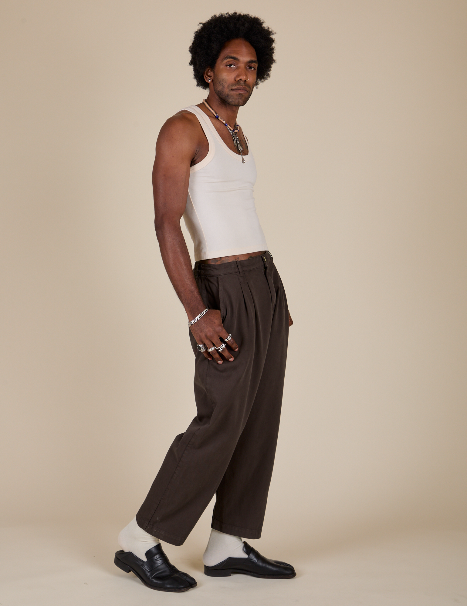 Side view of Heavyweight Trousers in Espresso Brown and Tank Top in vintage tee off-white on Jerrod