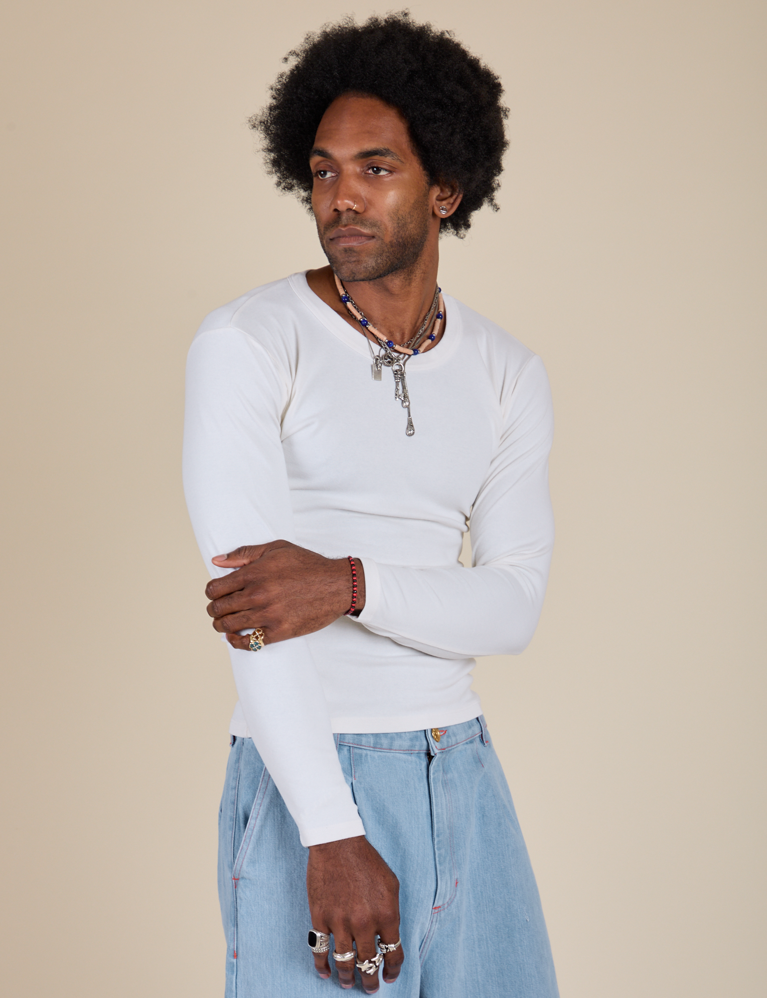 Jerrod is 6’3” and wearing S Long Sleeve Baby Tee in Vintage Tee Off-White