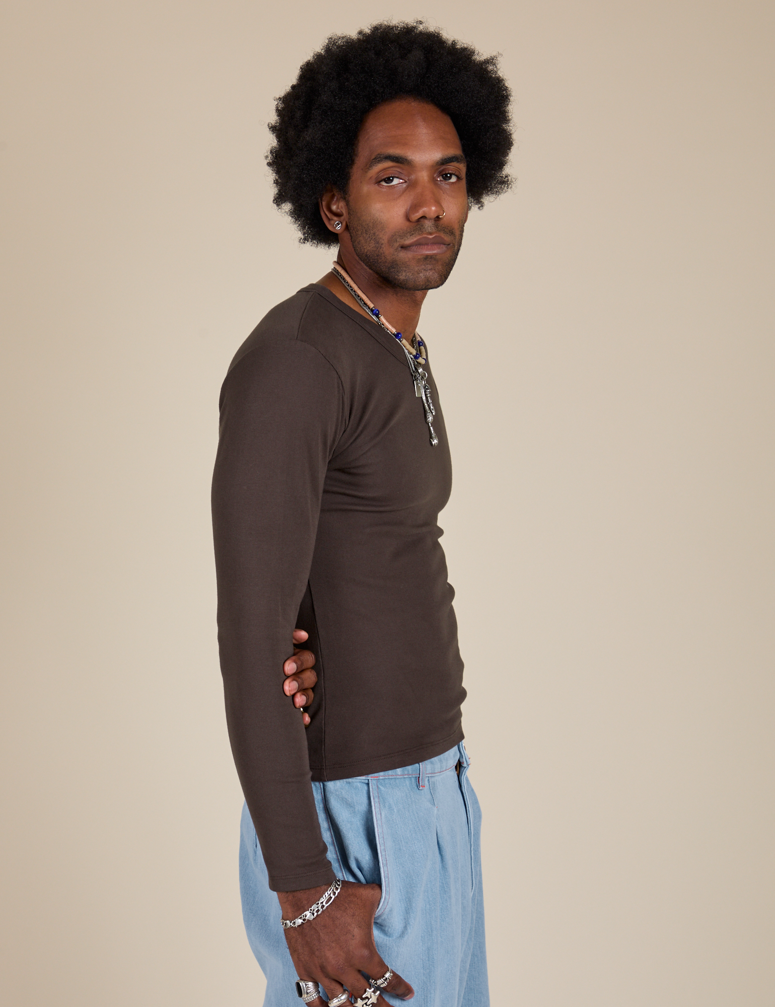 Long Sleeve Baby Tee in Espresso Brown side view on Jerrod