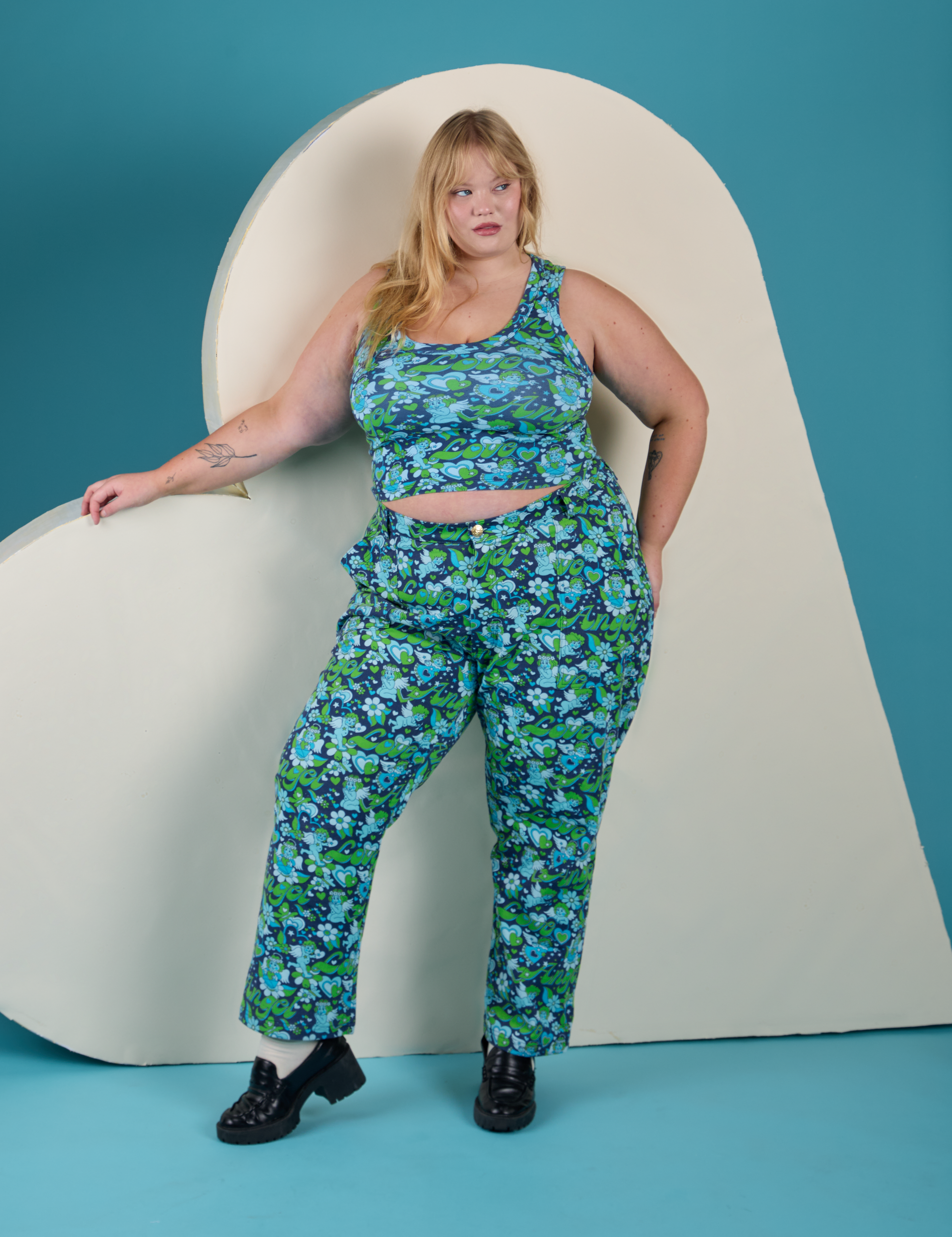 Juliet is wearing Cropped Tank Top in Angel Print and matching Work Pants