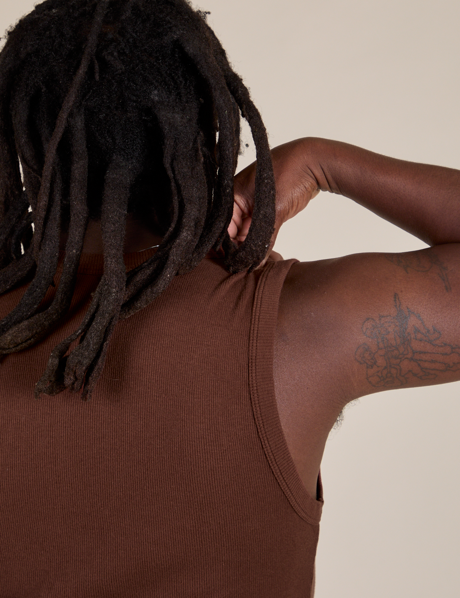 Back shoulder close up of Muscle Tee in Fudgesicle Brown on Demi