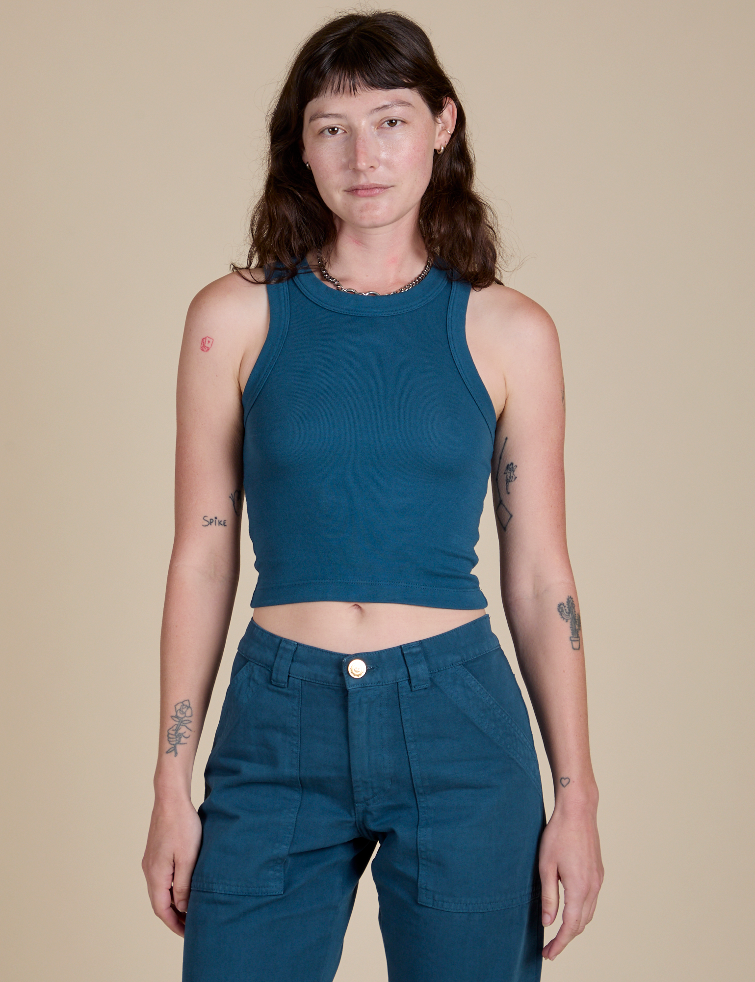 Alex is 5’8” and wearing P Racerback Tank in Lagoon