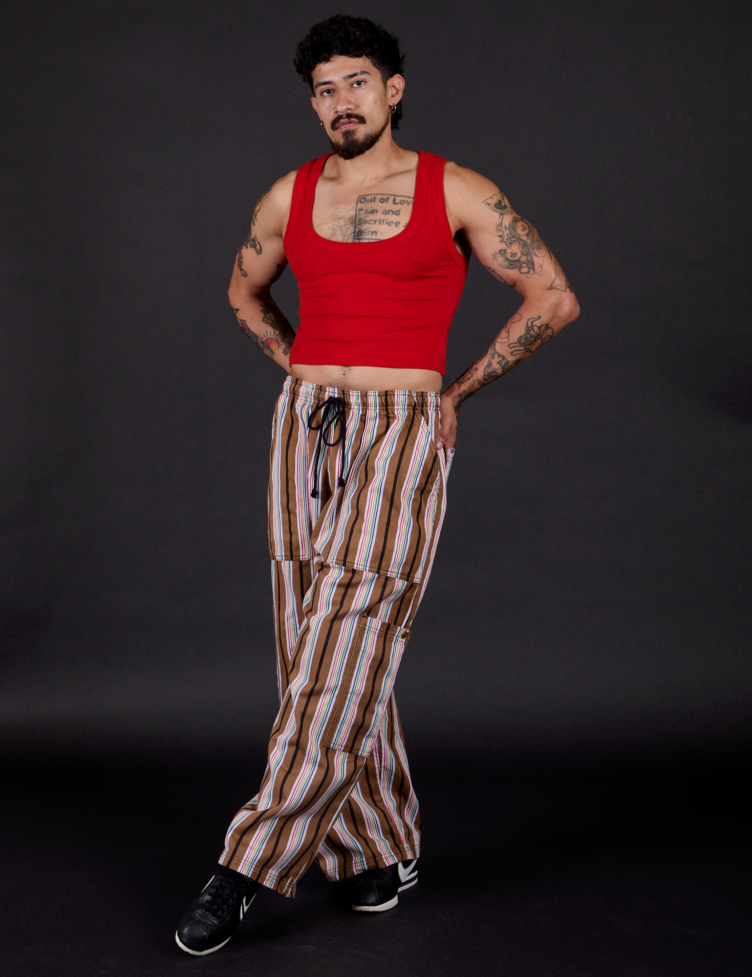 Striped Drop Pocket Pants in Retro Rainbow and mustang red Cropped Tank angled view on Jesse