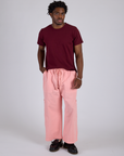 Isaac is 5’10” and wearing M Drop Pocket Cargo Pants in Baby Pink and red wine Organic Vintage Tee