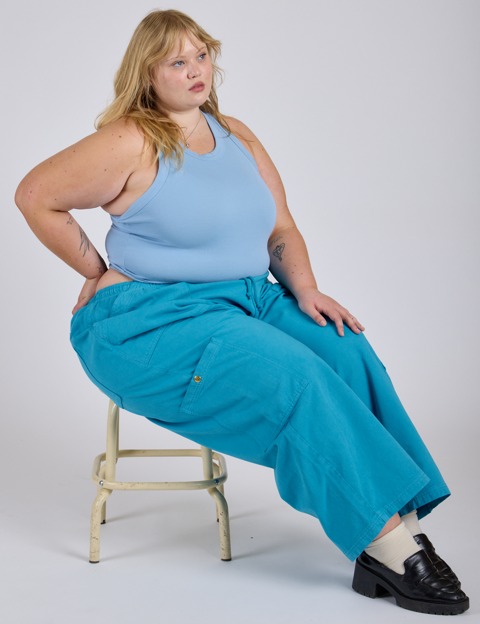 Juliet is wearing Drop Pocket Cargo Pants in Hawaiian Blue and baby blue Racerback Tank