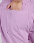 Close up of Juliet's hand in the back pocket of Drop Pocket Cargo Pants in Lilac Purple