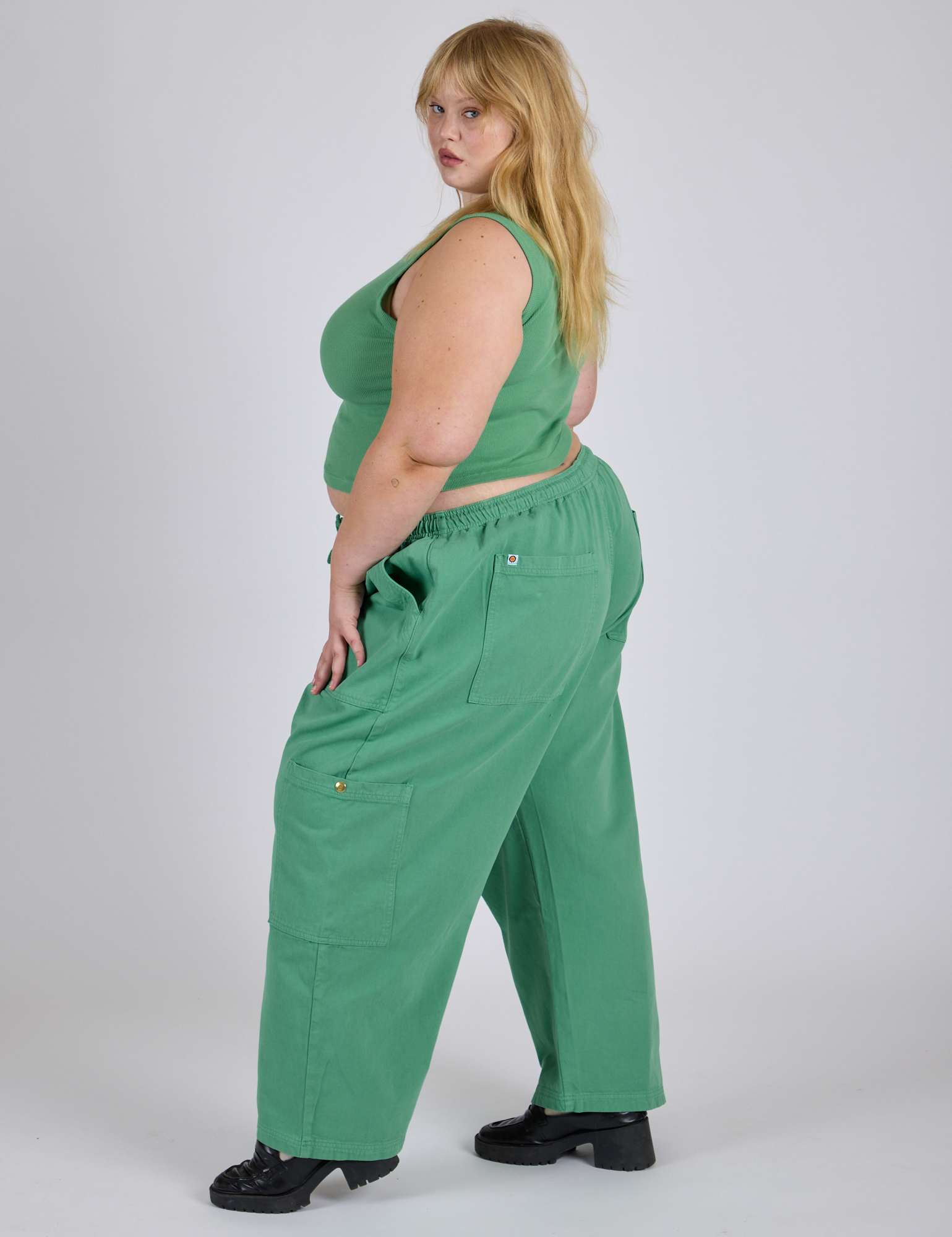 Side view of Drop Pocket Cargo Pants in Seafoam Green and matching Muscle Tee on Juliet