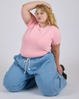 Juliet is wearing Jr. Varsity Tee in Baby Pink and light wash Denim Drop Pocket Pants